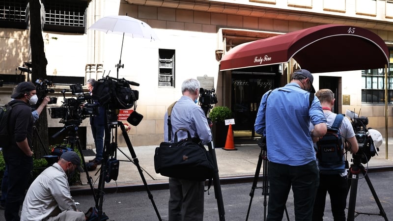 Members of the media gather outside Rudy Giuliani's apartment complex in New York
