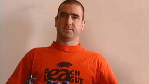 Eric Cantona in a red t-shirt