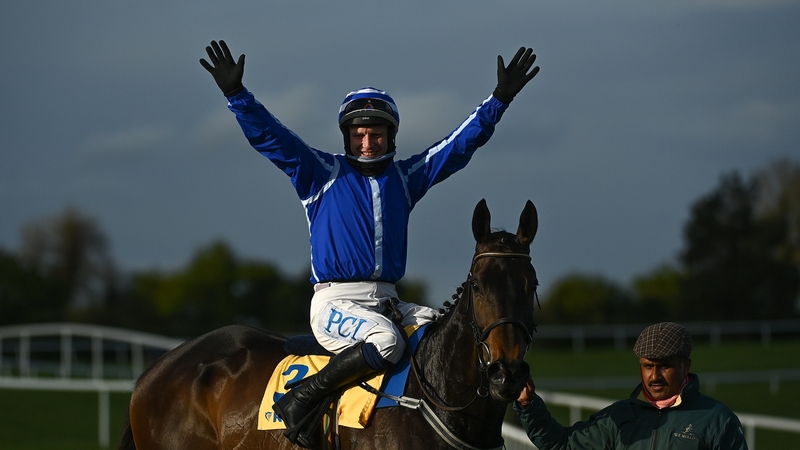Jockey Paul Townend celebrates with Energumene and groom Imran Haider after winning the Ryanair Novice Steeplechase