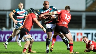 Nemani Nadolo is tackled by Nick Timoney and Stuart McCloskey