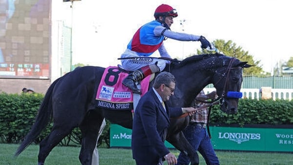 John Velasquez pours water on Medina Spirit to cool the horse down afterwards