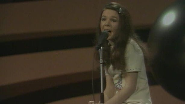 Eurovision winner Dana singing into a microphone