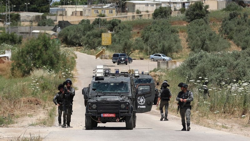 Members of the Israeli security bar the road near the Salem checkpoint leading to the West Bank town of Jenin