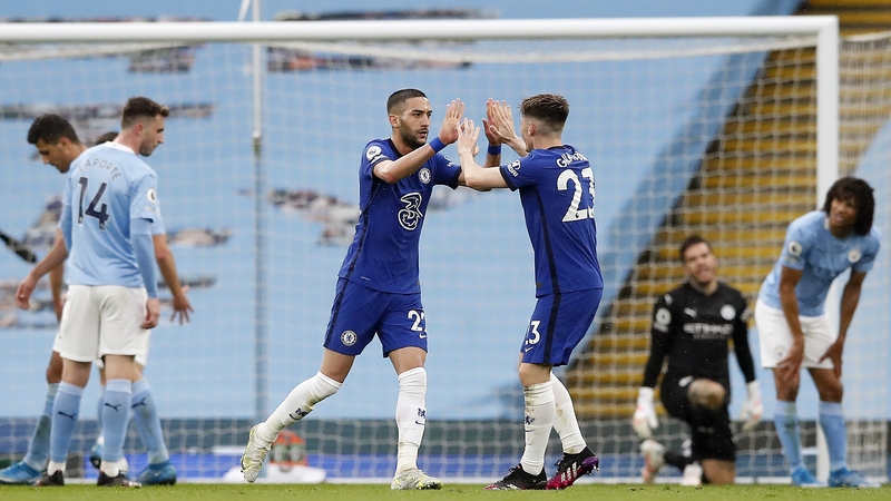 Hakim Ziyech celebrates with Billy Gilmour (R) after scoring the Chelsea equaliser