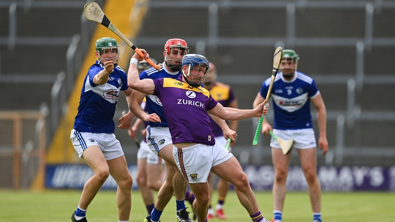 Wexford's Kevin Foley takes the hurley of Laois' Sean Downey