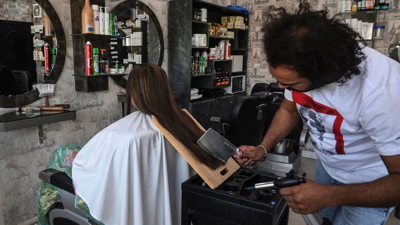 Pakistani barber Ali Abbas cutting hair with a cleaver