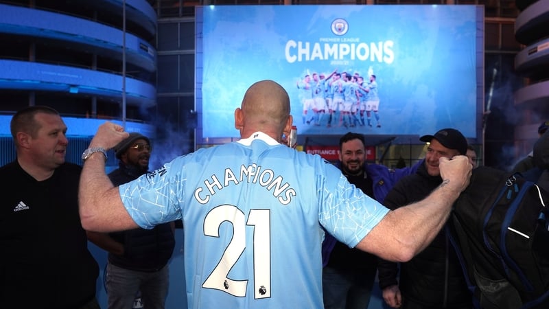 Fans outside the Etihad Stadium celebrate a fifth league title in a decade