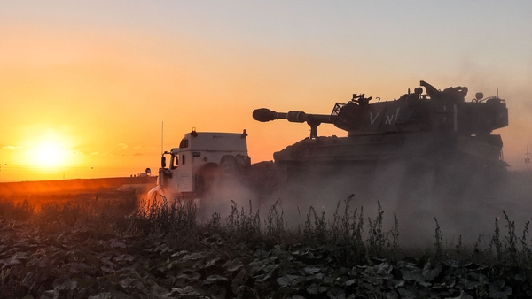 An Israeli tank, loaded on a trailer, at the Gaza border