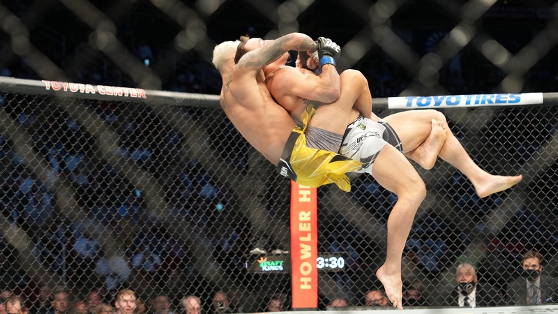 Charles Oliveira (L) takes down Michael Chandler
