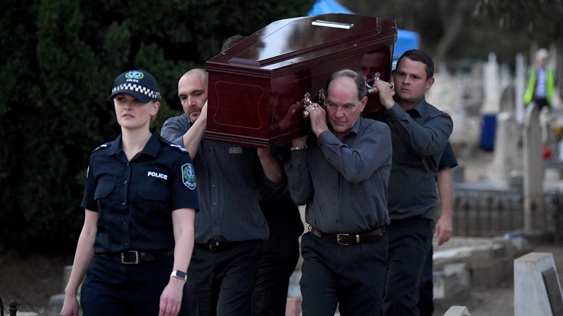 Adelaide Cemetery Authority pall bearers carry the body of 'Somerton Man' after Forensic Science SA, South Australia Police, major crime detectives and staff from the West Terrace cemetery exhumed the remains in Adelaide