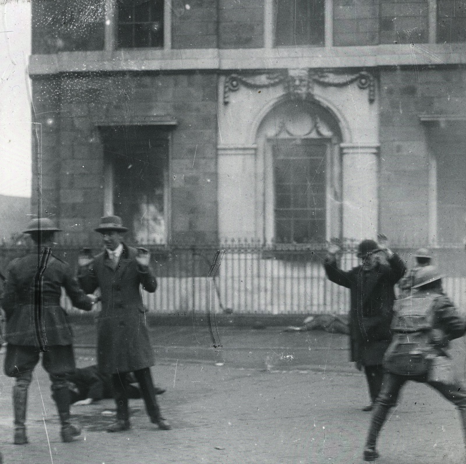 Men escaping from the building are challenged by troops; are they civilians or Volunteers? Credit: South Dublin County Libraries.