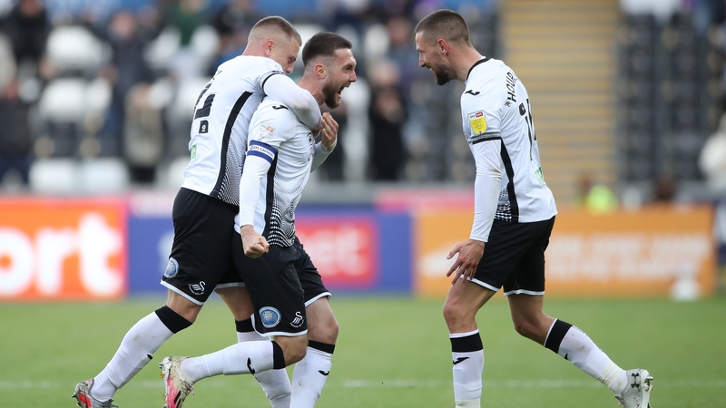 Swansea City's Matt Grimes (C) celebrates with Jake Bidwell (L) and Conor Hourihane after scoring
