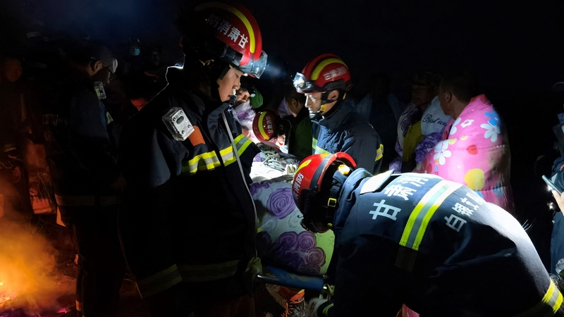 Rescuers assist race participants following the freezing rain