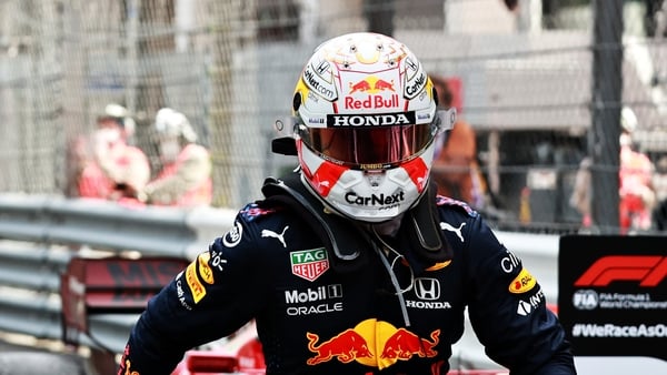 Verstappen runs towards his team to celebrate in parc ferme