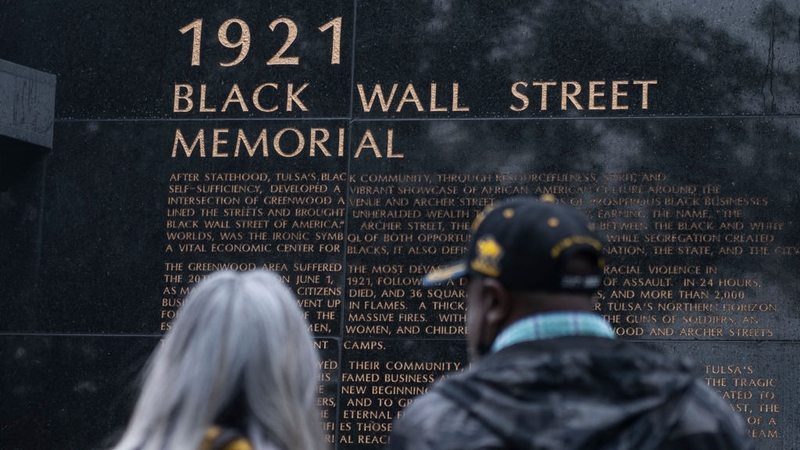 People look at the 1921 Black Wall Street Memorial on the 100th anniversary of the Greenwood massacre in Tulsa, Oklahoma