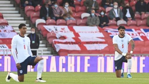Jude Bellingham and Tyrone Mings take the knee ahead of the friendly against Austria