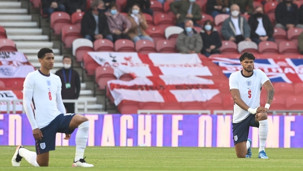 Jude Bellingham and Tyrone Mings take the knee ahead of the friendly against Austria