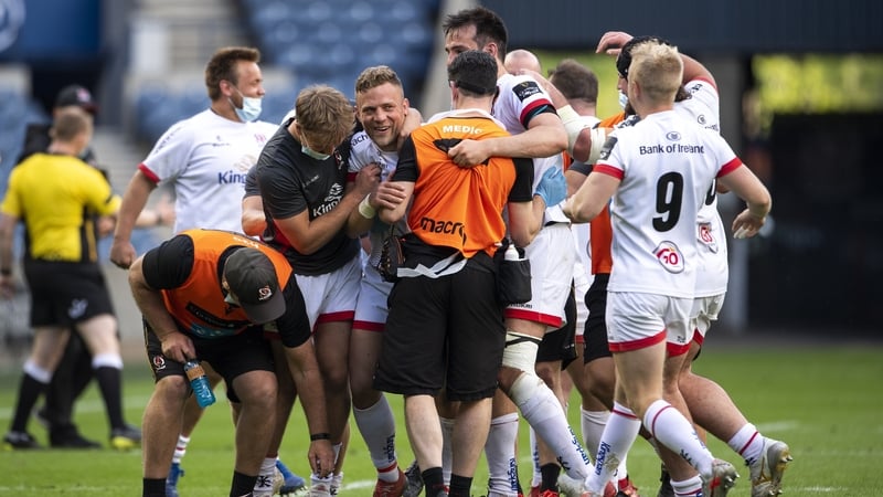 Ian Madigan is mobbed by his teammates after nabbing victory at the death in the Scottish capital