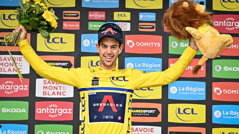Richie Porte celebrates on the podium in the yellow jersey
