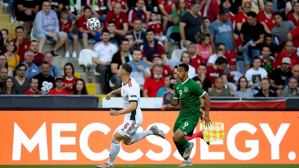 Adam Idah battles for possession with Willi Orban