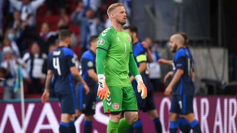 Kasper Schmeichel reacts as Finnish players celebrate their winning goal