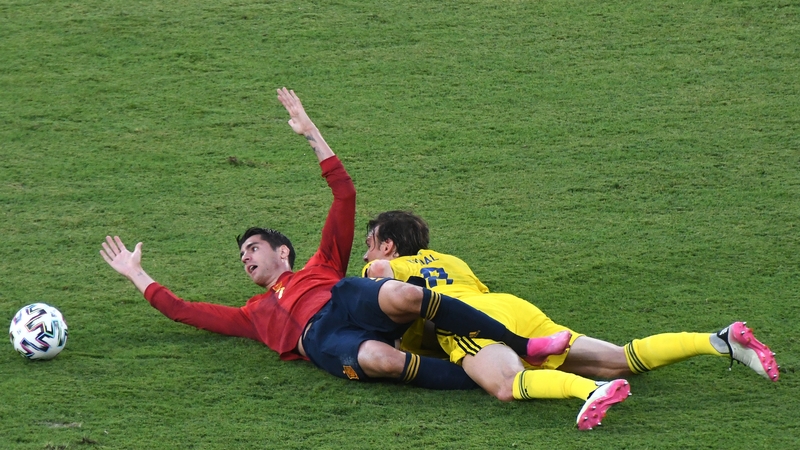Alvaro Morata and Albin Ekdal tangle during the Group E clash in Seville