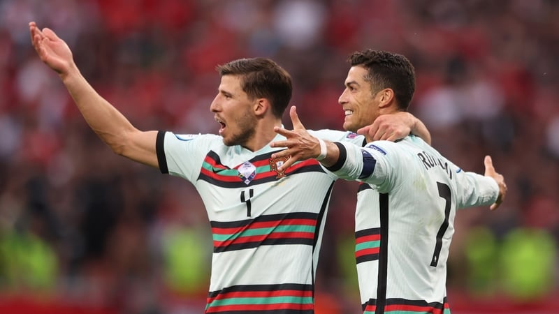 Cristiano Ronaldo celebrates with Ruben Dias after the third goal