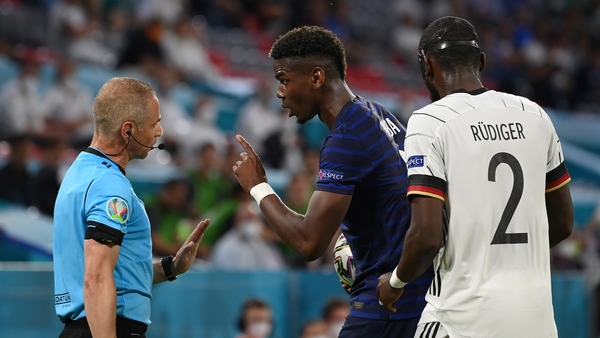 Pogba speaks with assistant referee, Juan Carlos Yuste after the incident