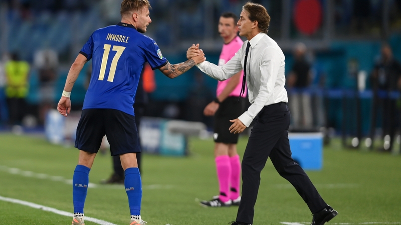 Ciro Immobile is congratulated by Roberto Mancini after scoring Italy's third goal against Switzerland