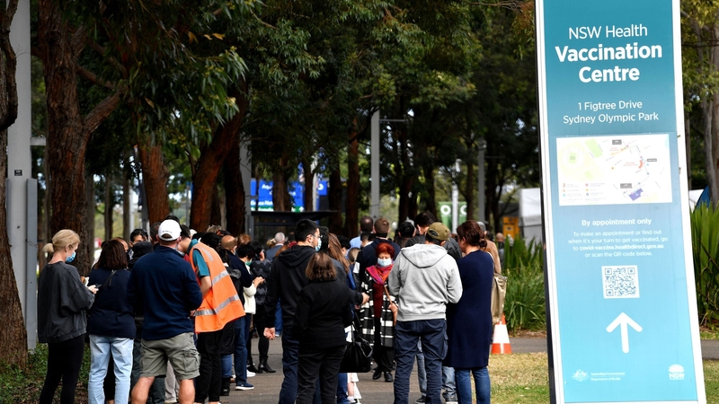 People queue outside a vaccination centre in Sydney