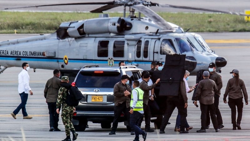 Colombia's President Ivan Duque walks surrounded by bodyguards at Camilo Daza International Airport