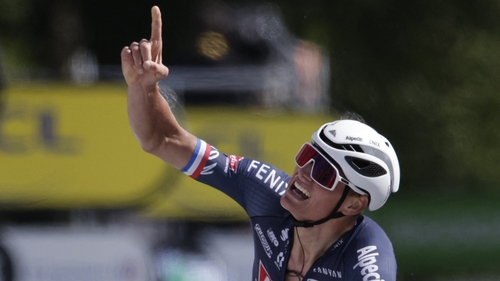 Van der Poel points skyward in celebration as he crosses the finish line