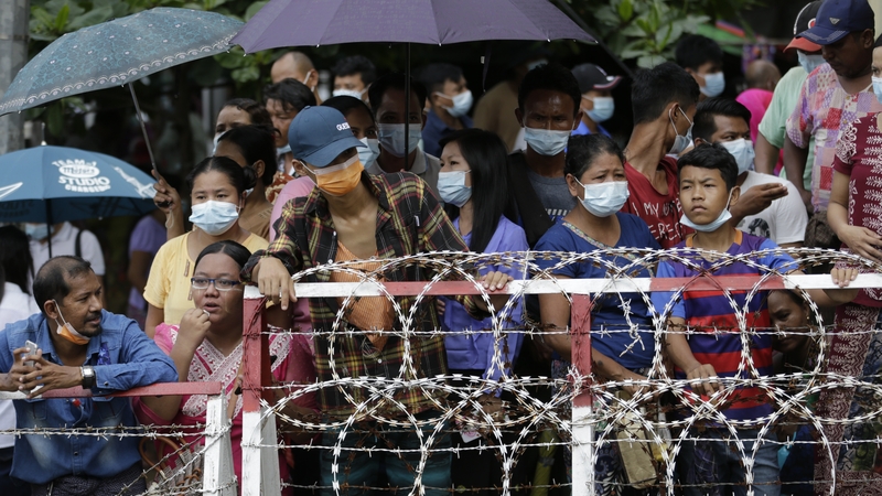 People wait for their relatives to be released from the Insein prison compound in Yangon