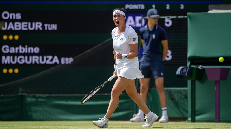 Ons Jabeur celebrates a point against Garbine Muguruza