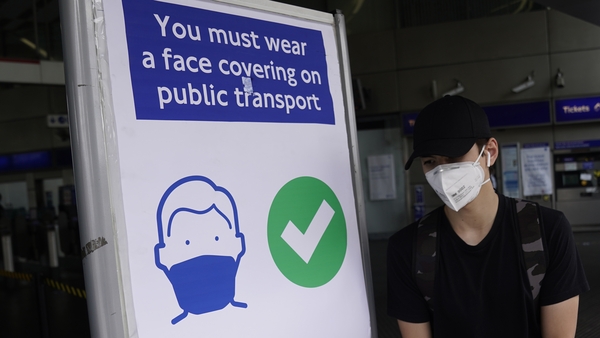 A commuter wears a face mask while on the London Underground