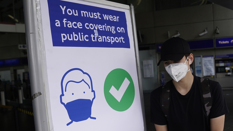 A commuter wears a face mask while on the London Underground