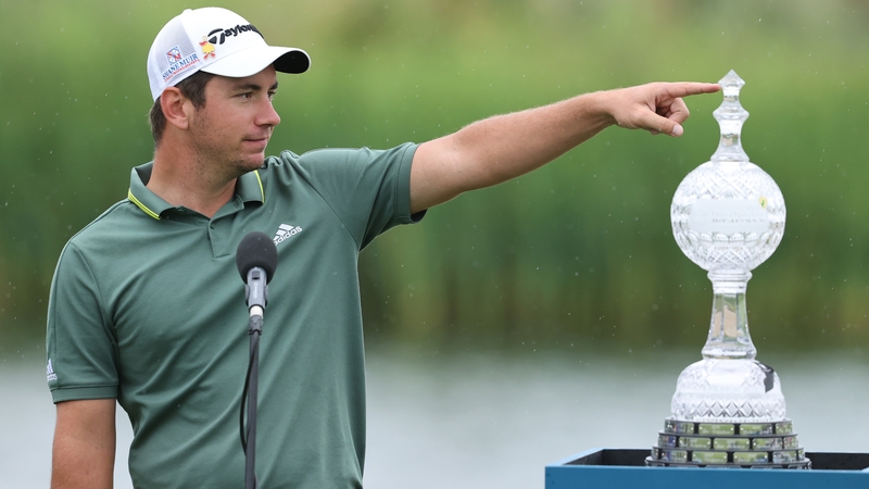 Lucas Herbert poses with the winner's trophy