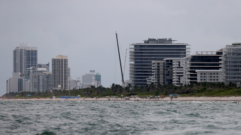 Cranes mark the skyline where the apartment block stood in Surfside, Florida