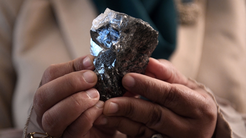 A member of the Botswana cabinet holds a 1,174-carat diamond in Gaborone, Botswana