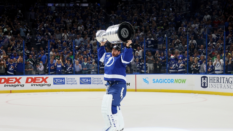 Curtis McElhinney of the Tampa Bay Lightning hoists the Stanley Cup