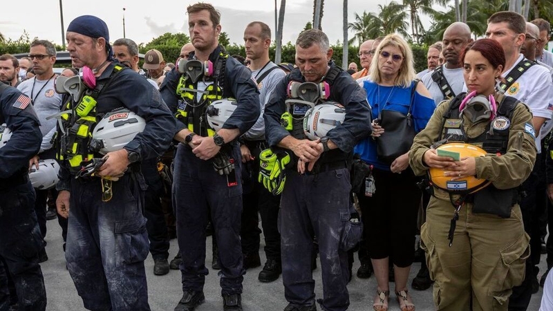 Search and rescue team members gathered in silence to remember the victims of the collapse