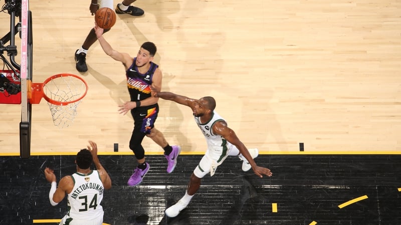 Devin Booker #1 of the Phoenix Suns drives to the basket