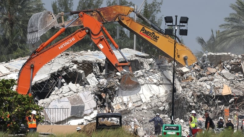 Crews have whittled down the size of the building debris pile from four or five stories to nearly ground level