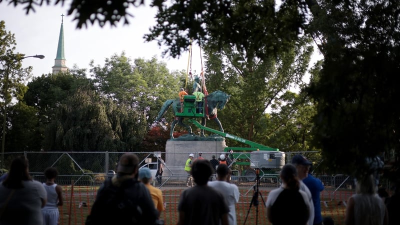 Onlookers cheered as the statue was put on a truck and driven away