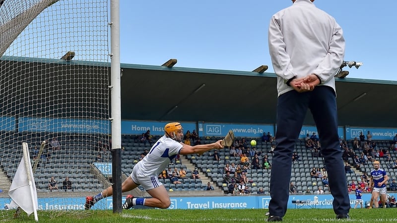 Laois goalkeeper Enda Rowland saves a penalty from Antrim's Neil McManus