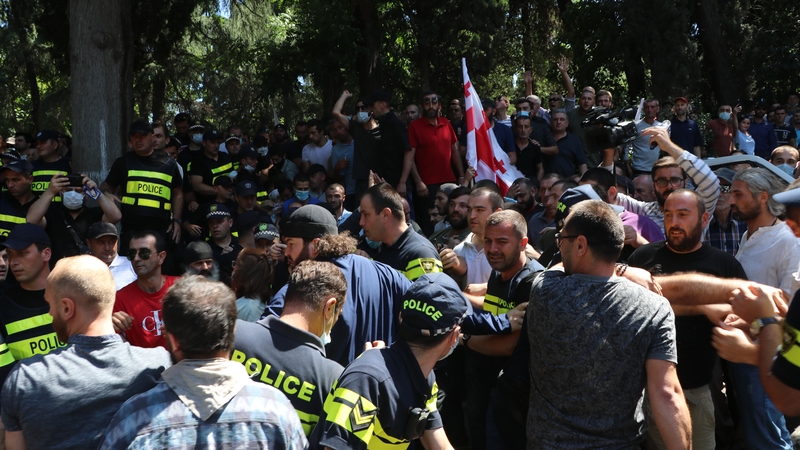 Police intervened after people tried to attack journalists during a protest against a Pride march