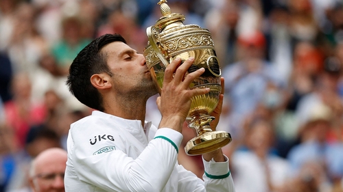 Novak Djokovic kisses the winner's trophy