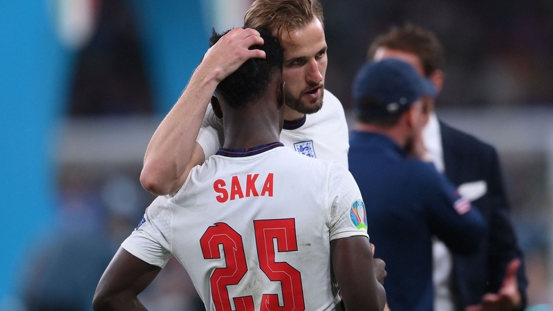 England captain Harry Kane consoles Bukayo Saka after the latter's penalty miss