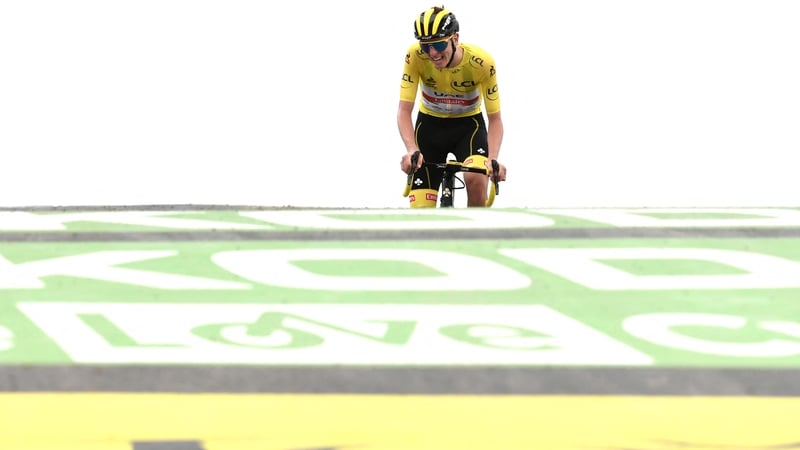 Tadej Pogacar crosses the finish line to extend his lead in the yellow jersey