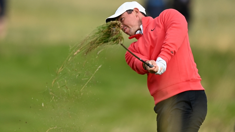 Rory McIlroy plays from the rough on the 12th hole